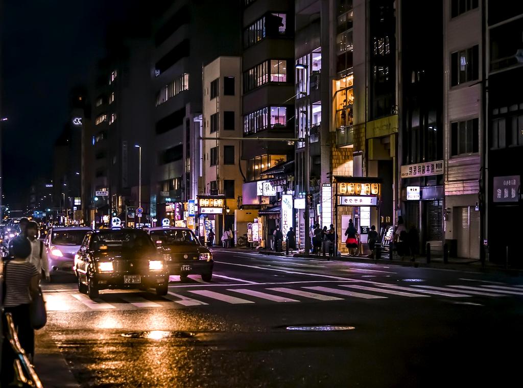 Cyberpunk city street with neon lights and holographic advertisements at night