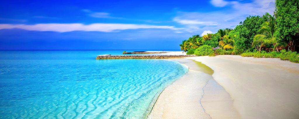 Tropical island with crystal clear water and floating solar platforms